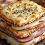 Looking for a quick and tasty snack that’s both simple to make and delicious? These Ham and Swiss Cracker Melts are the perfect solution. Made with buttery Ritz crackers, savory ham, and gooey Swiss cheese, these mini sandwiches are packed with flavor. Topped with a Dijon mustard and butter glaze and baked to perfection, they’re great for parties, gatherings, or a quick snack at home.