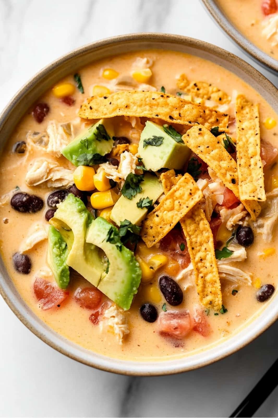 This Easy Chicken Taco Soup recipe is a creamy, flavorful meal ready in just 35 minutes! Made with rotisserie chicken, cream cheese, and simple pantry staples for a quick, hearty dish.