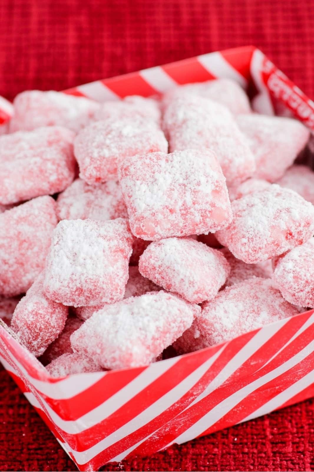 This Candy Cane Peppermint Puppy Chow recipe is a festive holiday treat! Chex cereal coated in peppermint baking chips, powdered sugar, and crushed candy canes makes a perfect Christmas snack.








