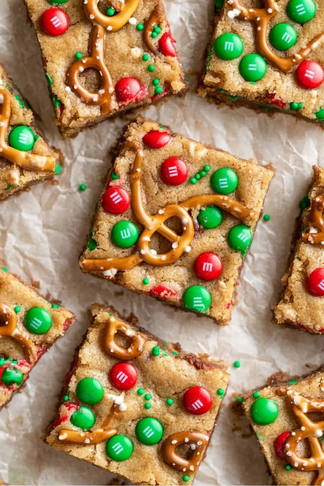 These festive Christmas cookie bars are loaded with chocolate chips, M&Ms, pretzels, caramels, and holiday sprinkles for the ultimate holiday treat. Soft, chewy, and easy to make, they’re perfect for parties or gift-giving!