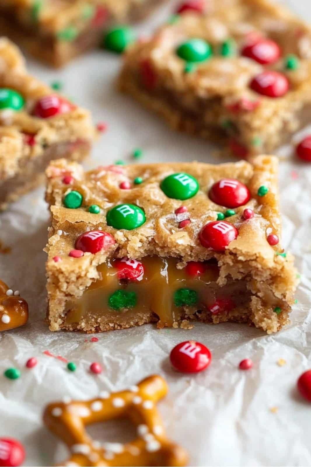 These festive Christmas cookie bars are loaded with chocolate chips, M&Ms, pretzels, caramels, and holiday sprinkles for the ultimate holiday treat. Soft, chewy, and easy to make, they’re perfect for parties or gift-giving!