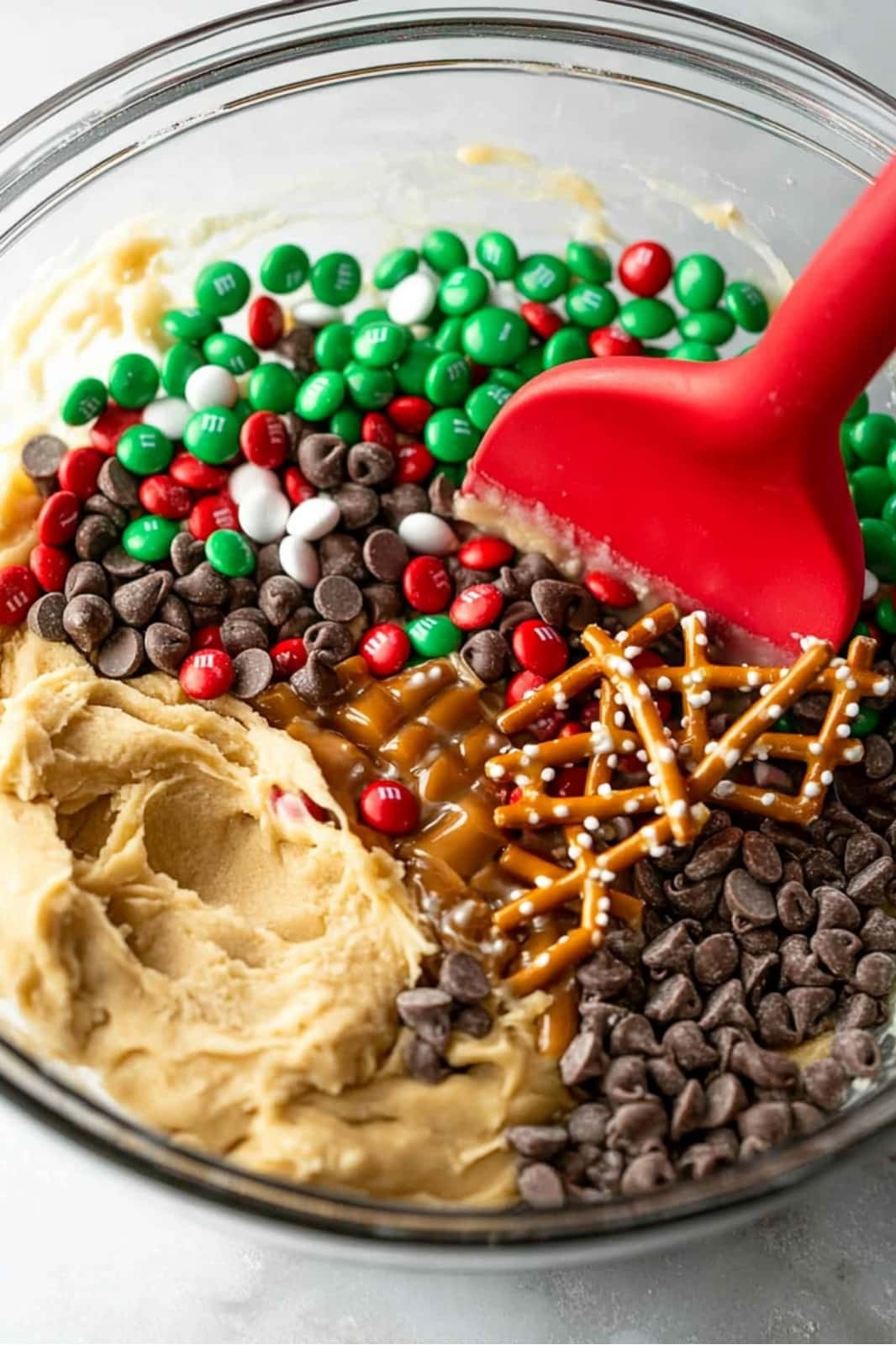 These festive Christmas cookie bars are loaded with chocolate chips, M&Ms, pretzels, caramels, and holiday sprinkles for the ultimate holiday treat. Soft, chewy, and easy to make, they’re perfect for parties or gift-giving!