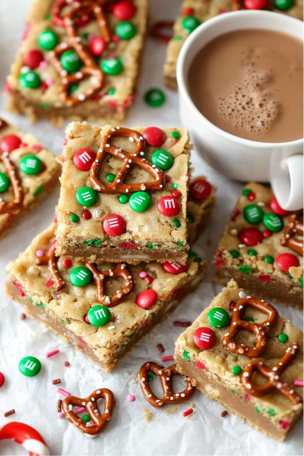 These festive Christmas cookie bars are loaded with chocolate chips, M&Ms, pretzels, caramels, and holiday sprinkles for the ultimate holiday treat. Soft, chewy, and easy to make, they’re perfect for parties or gift-giving!