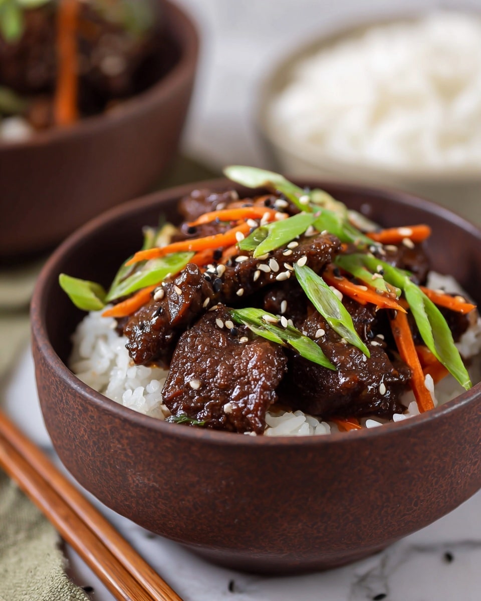 A close-up of a brown bowl filled with white rice at the bottom layer, topped with dark brown glazed beef pieces as the second layer, with thin orange carrot strips mixed in, and garnished with fresh bright green sliced scallions and sprinkled black and white sesame seeds on top. The bowl sits on a white marbled surface with a blurred plain white bowl of rice in the background and wooden chopsticks in front. Photo taken with an iphone --ar 4:5 --v 7
