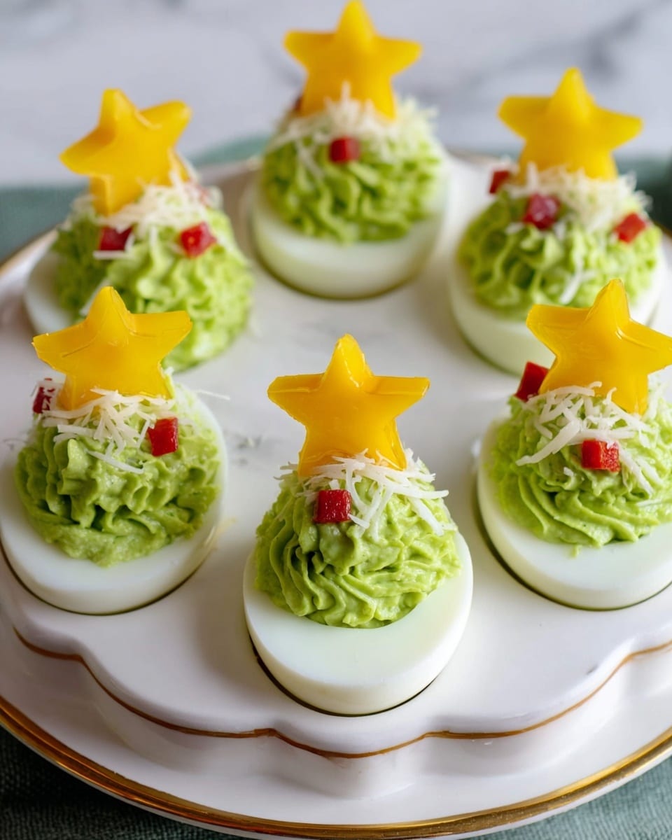 Christmas Tree Avocado Deviled Eggs Recipe 6 The image shows six deviled eggs arranged in a white egg holder with a gold rim, sitting on a white marbled surface. Each egg has a smooth white base with a vibrant green creamy filling piped in a swirl that looks like a small tree with texture. Tiny red diced pieces are scattered on the green filling as decoration. On top of each green swirl, there is a yellow star-shaped piece that looks like cheese or bell pepper, acting as a tree topper. Light bits of shredded white garnish are sprinkled over the green filling. The setup is neat and festive, designed to look like small Christmas trees. photo taken with an iphone --ar 4:5 --v 7