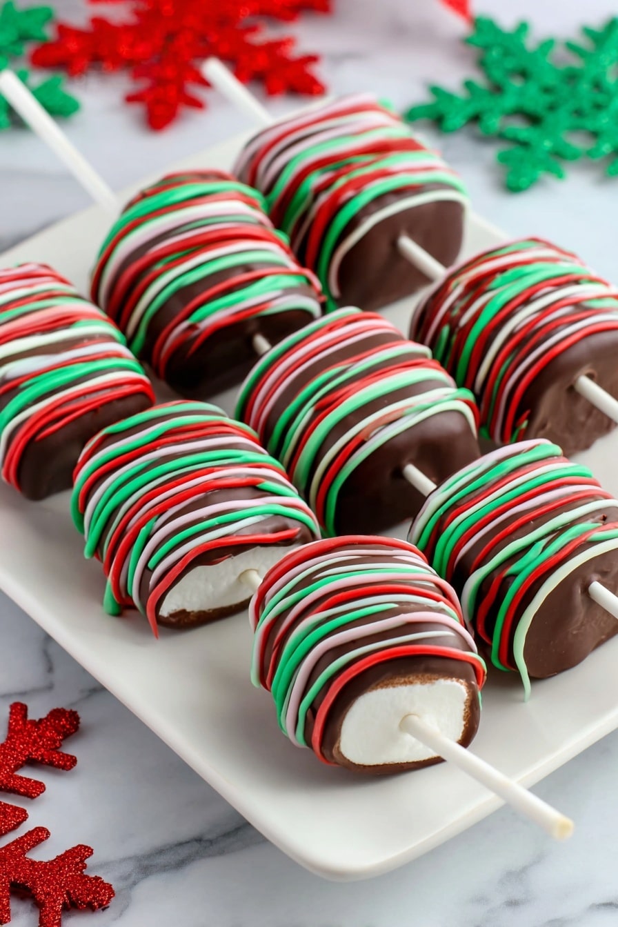 Christmas Marshmallow Pop Recipe 8 Four chocolate-covered marshmallows on white sticks are lined up closely on a white marbled surface. Each marshmallow is fully coated in smooth, shiny dark chocolate and decorated with thin, bright red, green, and white icing lines drizzled evenly around in a random crisscross pattern. The marshmallows are cylindrical and visible at the ends with the white stick inserted in the center of each. The colors stand out clearly against the rich brown chocolate, making them look festive and colorful. Photo taken with an iphone --ar 2:3 --v 7 - Christmas Marshmallow Pops, holiday marshmallow treats, festive marshmallow desserts, easy Christmas snacks, colorful holiday candies