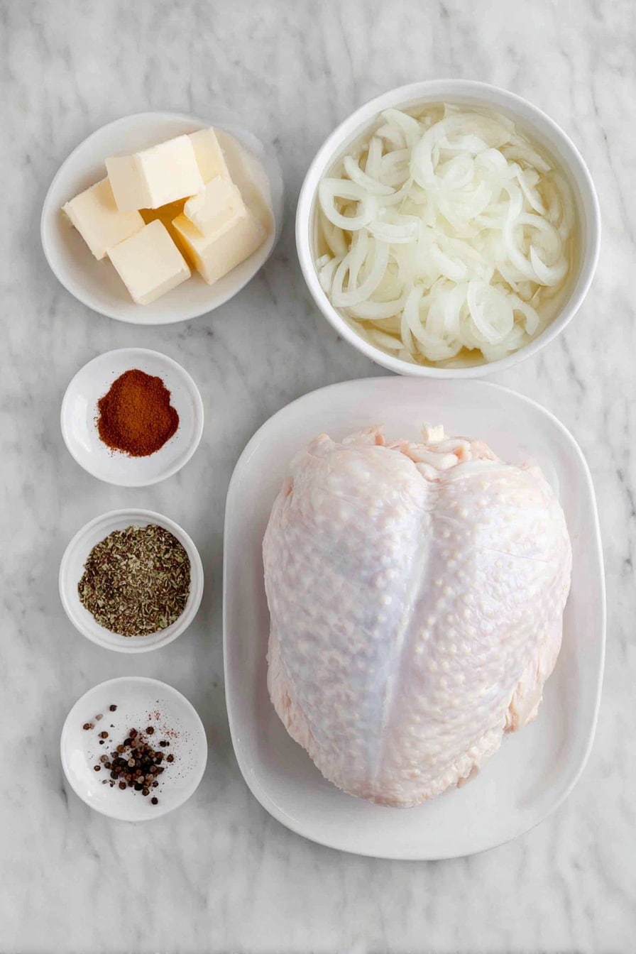 Slow Cooker Turkey Breast Recipe 7 Flat lay of a whole boneless turkey breast with natural skin, a small pile of garlic powder and smoked paprika powders side by side, a small mound of mixed poultry seasoning herbs, a pinch of coarse salt and black peppercorns scattered neatly, a simple white ceramic bowl filled with thinly sliced fresh onions, another white ceramic bowl containing clear chicken broth, and a few small cubes of unsalted butter arranged in a triangle on a white ceramic plate, all placed on a clean white marble surface, soft natural light, photo taken with an iPhone, professional food photography style, fresh ingredients, white ceramic bowls, no bottles, no duplicates, no utensils, no packaging --ar 2:3 --v 7 --p m7354615311229779997 - Slow Cooker Turkey Breast, easy turkey breast recipe, juicy turkey breast crockpot, tender turkey dinner, holiday turkey slow cooker