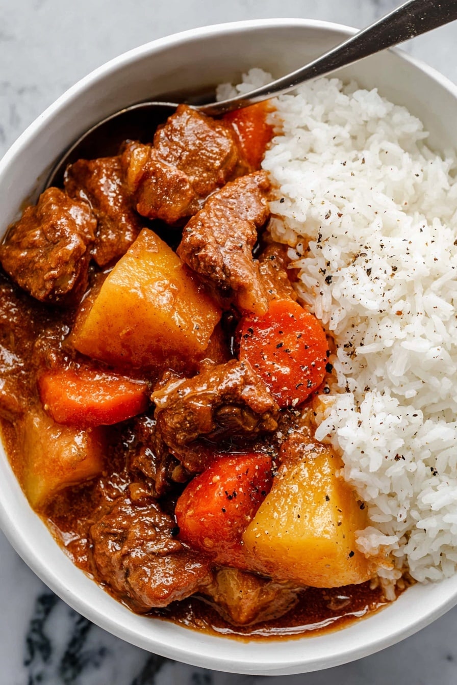Hawaiian Beef Stew Recipe 8 The image shows a close-up of a dark gray pot filled with thick brown stew. Inside the stew, there are chunks of brown meat, bright orange carrot pieces, and large yellow potato cubes scattered evenly throughout. A metal ladle with a rough handle is lifting some of the stew, showing a mix of meat, potato, and carrots with a smooth brown sauce coating everything. Next to the pot, there is a white bowl filled with fluffy white rice, which is placed on a white marbled surface. A gray and white checkered cloth is also visible under the pot. photo taken with an iphone --ar 2:3 --v 7 - Hawaiian Beef Stew, Hawaiian Beef Stew Recipe, Hawaiian Beef Stew, Hawaiian Stew with Beef, Hawaiian Beef Stew Flavor
