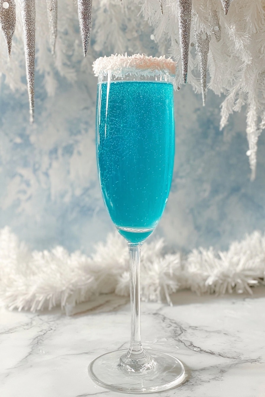 Blue Curacao Mimosa Recipe 8 A tall clear glass flute filled with a bright blue sparkling drink that has small bubbles visible inside. The rim of the glass is coated with a layer of white shredded coconut flakes. The glass stands on a white marbled surface with a background of soft, fluffy white decorations and icicle-shaped ornaments hanging above. The lighting makes the blue drink look fresh and vibrant. photo taken with an iphone --ar 2:3 --v 7 - Blue Curacao Mimosa, Blue Curacao cocktail, tropical brunch drinks, colorful champagne cocktail, vibrant mimosa recipe