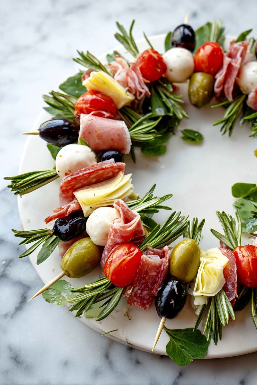 A round wreath made of many small skewers layered closely together on a white plate. Each skewer has a green rosemary sprig at the base, topped with a folded slice of pink salami, a pale yellow artichoke heart piece, a white soft mozzarella ball, a black olive, a green olive stuffed with red, a bright red cherry tomato, and a small green pickle. The colors are red, green, white, and black, with fresh green leaves scattered for decoration. The plate is on a white marbled surface. photo taken with an iphone --ar 2:3 --v 7 - Cheese and Charcuterie Wreath Platter, festive cheese board ideas, holiday party appetizer, eye-catching cheese platter, DIY cheese and meat wreath