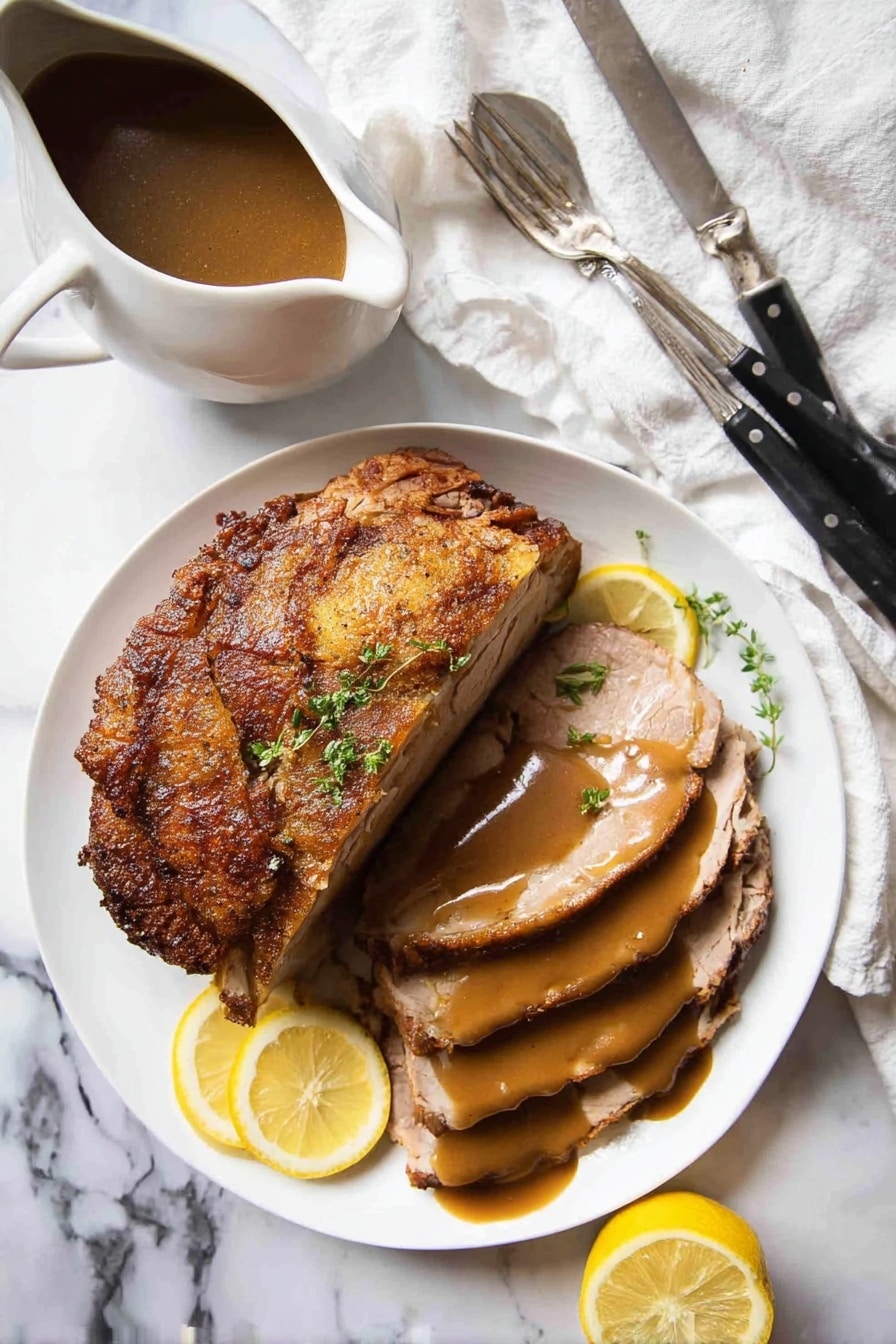 A white plate holds several thin slices of light brown cooked meat laid in a slightly overlapping fashion. A thick, smooth medium brown sauce is being poured from above onto the meat, creating a small pool on top. Behind the sliced meat is a larger, vertical piece of the same meat showing its light interior and browned crust on top. To the back left on the plate, two small wedges of bright yellow lemon add a fresh touch. The plate sits on a white marbled surface with a soft, white cloth slightly visible in the background. photo taken with an iphone --ar 2:3 --v 7 - Slow Cooker Juicy Turkey Breast, turkey breast slow cooker, moist turkey recipes, easy turkey for holidays, crispy skin turkey