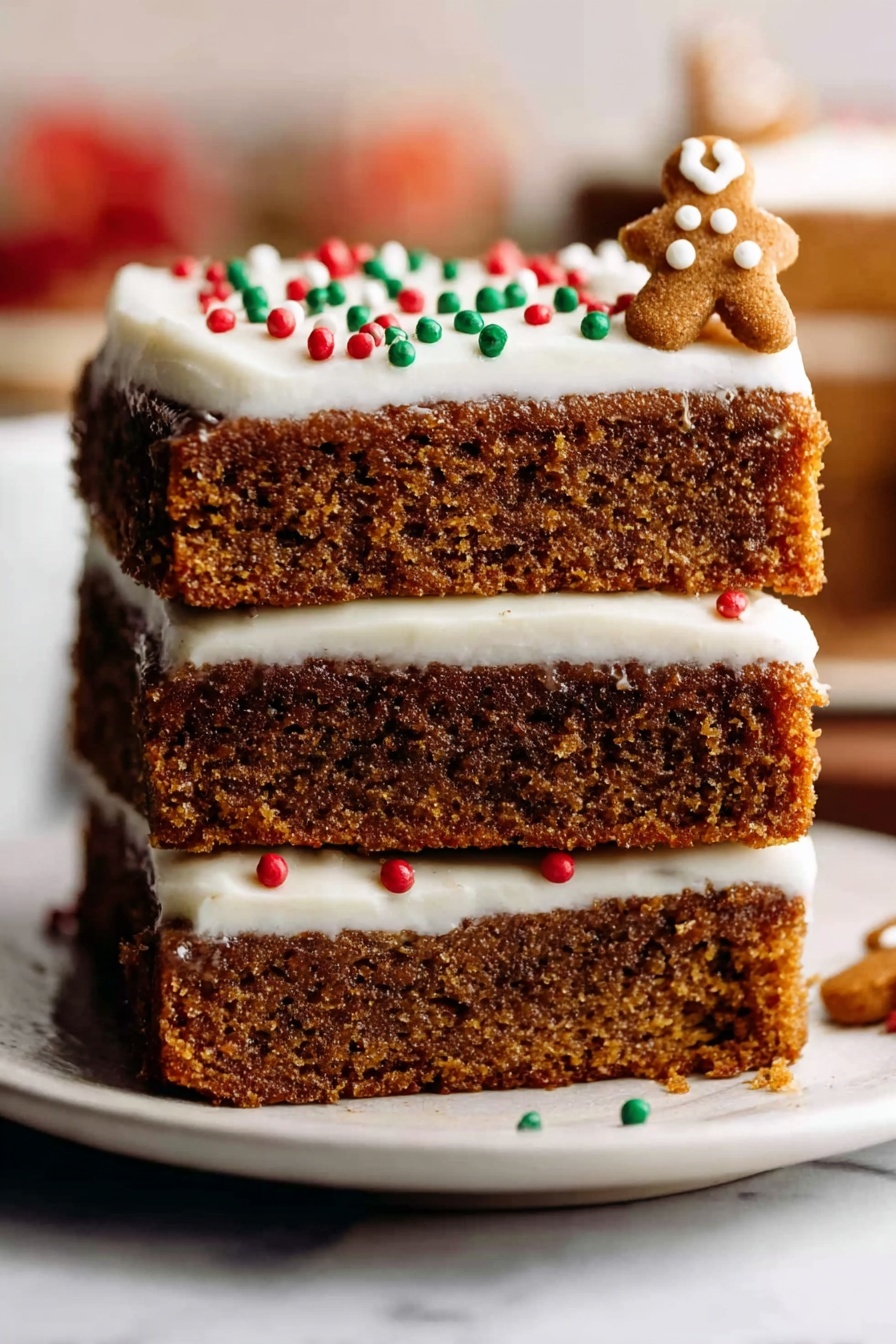 Gingerbread Cookie Bars Recipe 8 A stack of three thick, soft brown cake layers with a moist texture sits on a white plate placed on a white marbled surface. The top layer is covered with smooth white frosting, decorated with small round red, green, and white sprinkles, and a few small gingerbread-shaped decorations on the right side. The background is blurred with warm colors, making the cake the clear focus. photo taken with an iphone --ar 2:3 --v 7 - Gingerbread Cookie Bars, holiday cookie bars, spiced gingerbread bars, easy gingerbread dessert, winter baking treats
