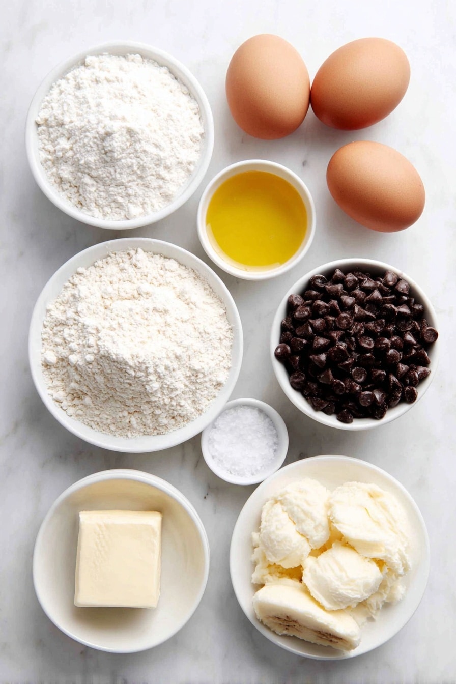 Flat lay of a small mound of all-purpose flour, a small white bowl with baking soda powder, a small white bowl with salt crystals, a pat of unsalted butter slightly melting, a small white bowl filled with golden vegetable oil, a small white bowl of granulated sugar, two whole uncracked brown eggs, a small white bowl of vanilla extract, a white ceramic plate with peeled ripe bananas mashed roughly, and a simple white ceramic bowl filled with semi-sweet chocolate chips, all arranged in perfect symmetry on a clean white marble surface, soft natural light, photo taken with an iPhone, professional food photography style, fresh ingredients, white ceramic bowls, no bottles, no duplicates, no utensils, no packaging --ar 2:3 --v 7 --p m7354615311229779997 - Moist Chocolate Chip Banana Bread, banana bread with chocolate chips, easy banana bread recipe, moist banana bread, best chocolate chip banana bread