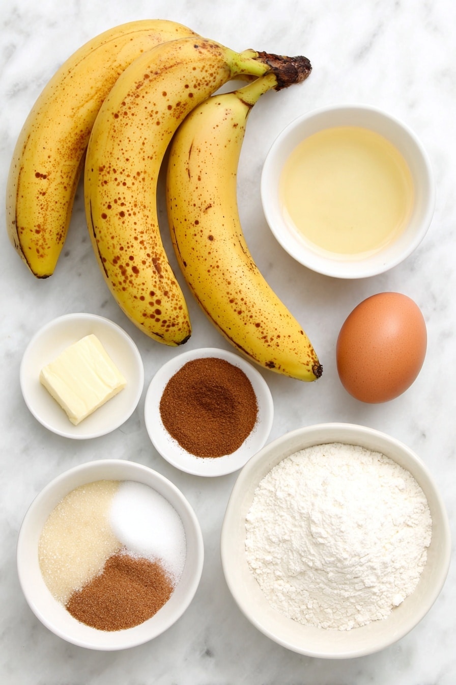 Flat lay of a few very ripe yellow bananas with brown spots, a small pile of granulated sugar, a chunk of golden melted butter, one whole large brown egg with a smooth shell, a small white ceramic bowl with clear vanilla extract, a small white ceramic bowl of baking soda powder, a small white ceramic bowl of ground cinnamon, a small white ceramic bowl of ground nutmeg, and a neat mound of white all-purpose flour, all arranged symmetrically on a clean white marble surface, soft natural light, photo taken with an iPhone, professional food photography style, fresh ingredients, white ceramic bowls, no bottles, no duplicates, no utensils, no packaging --ar 2:3 --v 7 --p m7354615311229779997 - Best Banana Bread, Easy Banana Bread, Moist Banana Bread, Homemade Banana Bread, Banana Bread with Ripe Bananas