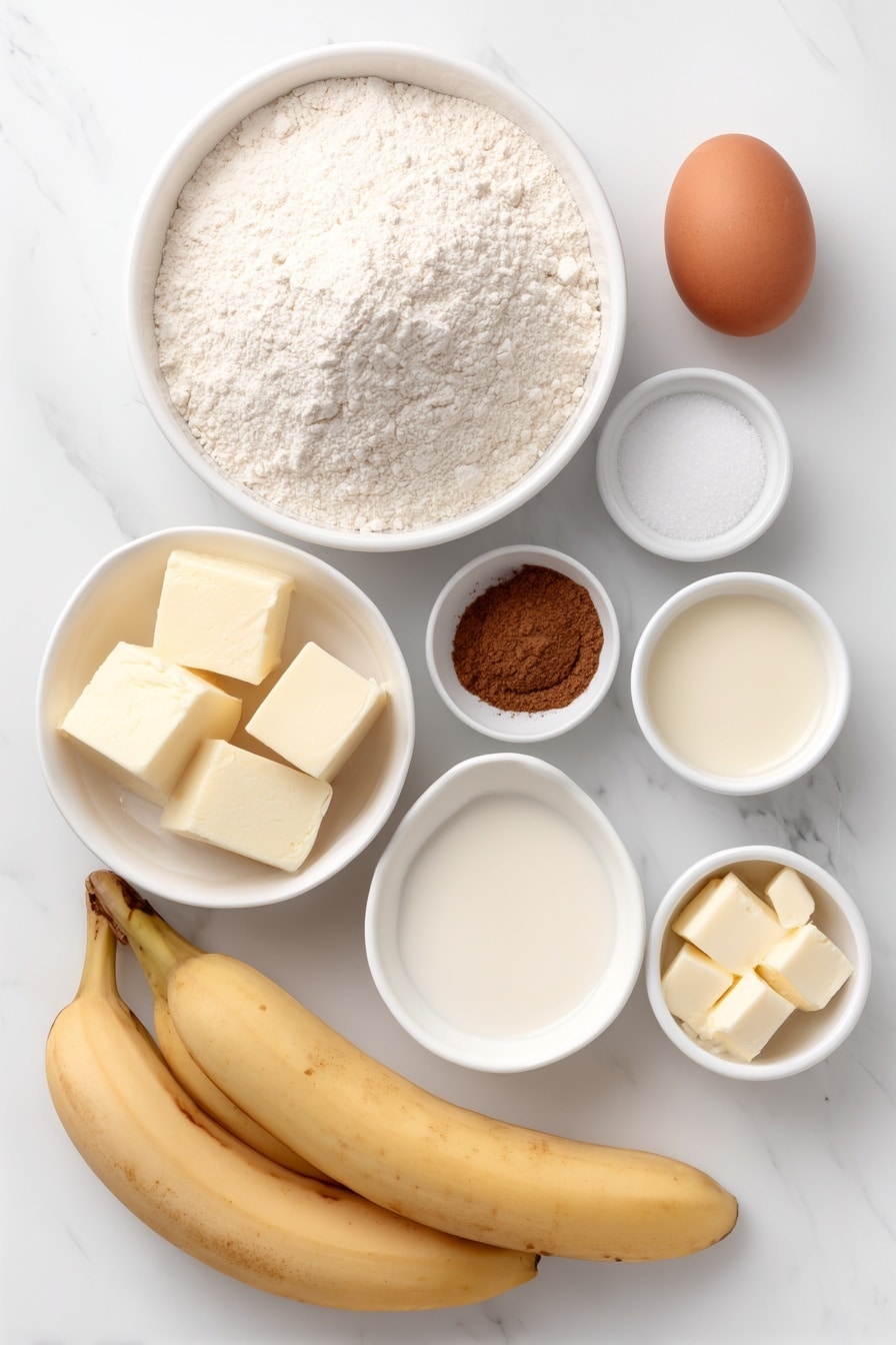 Flat lay of a small mound of all-purpose flour, a small white bowl with baking powder, a tiny white bowl with salt, a small white bowl containing ground cinnamon, a small white bowl filled with granulated sugar, two large ripe bananas, one large whole egg with a clean shell, a small white bowl of whole milk, a small white bowl of vanilla extract, a small white bowl of extra-light oil, a small white bowl with unsalted butter chunks, placed on a clean white marble surface, soft natural light, photo taken with an iPhone, professional food photography style, fresh ingredients, white ceramic bowls, no bottles, no duplicates, no utensils, no packaging --ar 2:3 --v 7 --p m7354615311229779997 - Banana Pancakes, Easy Banana Pancake, Fluffy Banana Pancakes, Quick Banana Breakfast, Ripe Banana Pancake