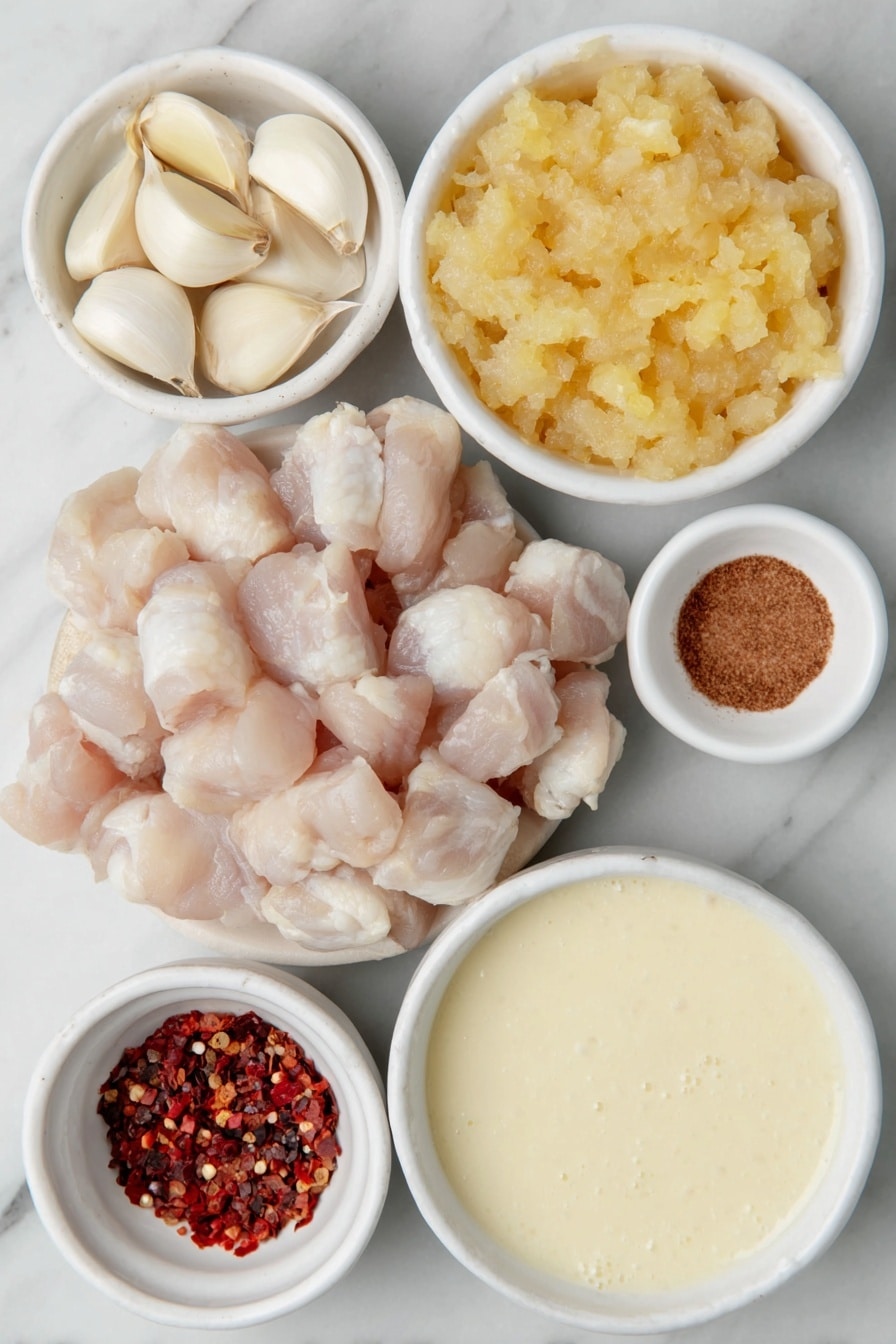 Easy Slow Cooker Chicken Curry Recipe 7 Flat lay of peeled garlic cloves, a small pile of fresh grated ginger, a small white ceramic bowl filled with medium curry powder, a small white ceramic bowl with red chili flakes, a small white ceramic bowl with salt crystals, a small white ceramic bowl holding bright golden mango chutney, a small white ceramic bowl filled with creamy reduced-fat coconut milk, a large peeled whole onion finely chopped and placed in a simple white ceramic bowl, raw boneless skinless chicken thighs arranged neatly, and a small white ceramic bowl containing fragrant garam masala powder placed on a clean white marble surface, soft natural light, photo taken with an iPhone, professional food photography style, fresh ingredients, white ceramic bowls, no bottles, no duplicates, no utensils, no packaging --ar 2:3 --v 7 --p m7354615311229779997 - Easy Slow Cooker Chicken Curry, slow cooker chicken curry, chicken curry recipe, flavorful chicken curry, simple slow cooker dinner