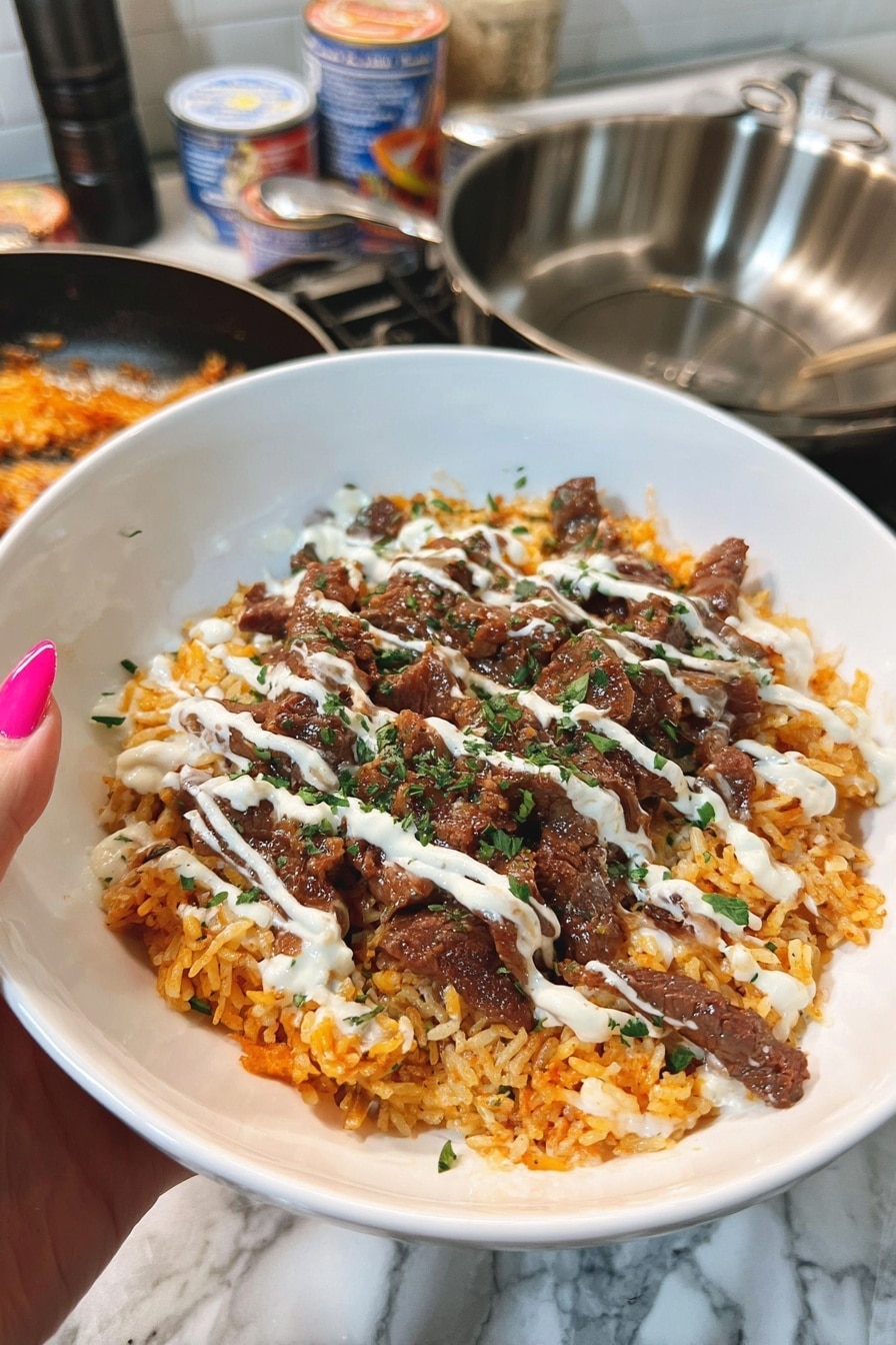 Steak and Queso Rice Recipe 8 A white bowl holds a layered dish starting with a base of orange-colored rice that has a slightly fluffy texture. On top of the rice, there are thin strips of cooked brown meat scattered evenly across the surface. The meat is drizzled with a creamy white sauce, adding a smooth texture and light color contrast. Small bits of chopped green herbs are sprinkled lightly over the top, adding a fresh touch. The background features a white marbled kitchen surface with cooking pans and cans nearby, while a woman's hand with pink nails holds the bowl on the left side. photo taken with an iphone --ar 2:3 --v 7 - Steak and Queso Rice, steak and queso rice, spicy steak and rice skillet, easy steak and queso dinner, comforting beef and cheese rice