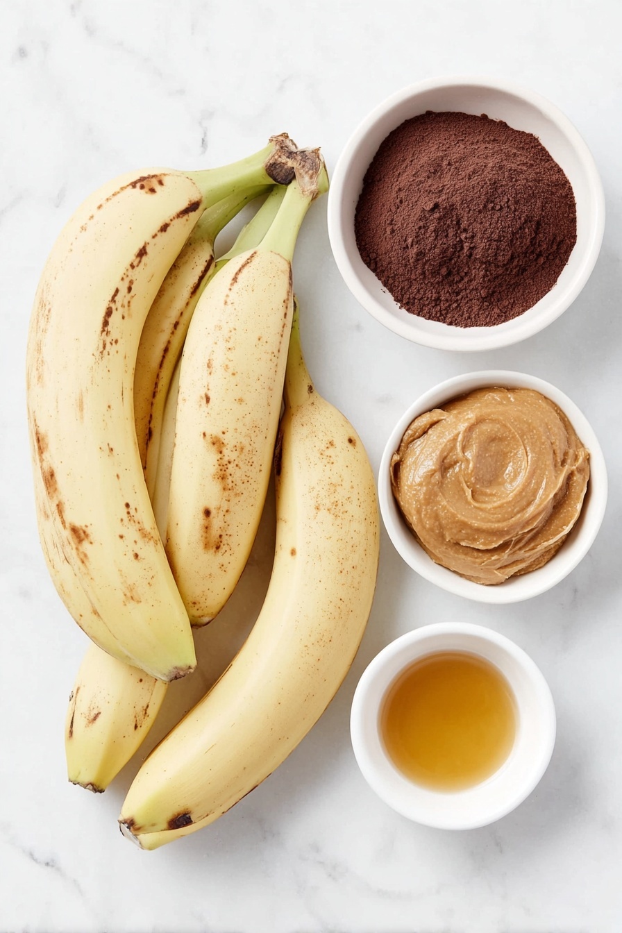 Banana Peanut Butter Fudge Brownies Recipe 7 Flat lay of three medium overripe bananas with a few brown spots, a small white ceramic bowl filled with smooth peanut butter, a small white ceramic bowl containing fine unsweetened cocoa powder, and a small white ceramic bowl holding golden maple syrup, all arranged symmetrically with balanced spacing, placed on a clean white marble surface, soft natural light, photo taken with an iPhone, professional food photography style, fresh ingredients, white ceramic bowls, no bottles, no duplicates, no utensils, no packaging --ar 2:3 --v 7 --p m7354615311229779997 - Banana Peanut Butter Fudge Brownies, healthy brownie recipes, egg-free gluten-free desserts, quick chocolate banana brownies, dairy-free fudge brownies